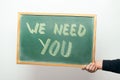 Chalkboard with WE NEED YOU handwritten in chalk Royalty Free Stock Photo