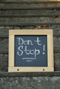 Chalkboard with phrase Don`t Stop on stone stairs outdoors Royalty Free Stock Photo