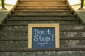 Chalkboard with phrase Don`t Stop on stone stairs outdoors Royalty Free Stock Photo