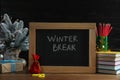 Chalkboard with phrase Winter Break, Christmas decor and stationery on wooden table. Holidays concept Royalty Free Stock Photo