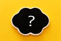Chalkboard with question mark sign over yellow background Royalty Free Stock Photo