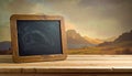 Chalkboard on Wooden Table with Dramatic Mountain Landscape and Cloudy Sky Background blackboard Royalty Free Stock Photo