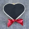 A chalkboard shaped heart on a sratched steel background