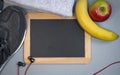 Chalkboard with sport shoes, headphones and fruits Nordic Walking