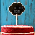 Chalkboard with the text I lovey you mom on a cake