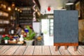 Chalkboard wood frame blackboard sign menu on wooden table, Blurred image background.