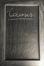 Chalkboard with wooden frame with french text `courses` for shopping list written layout template background