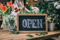 Chalkboard with word Open in floral shop