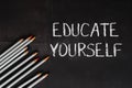 A chalkboard with the words educate yourself written on it Royalty Free Stock Photo