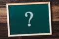 Chalkboard written QUESTION MARK on wooden table