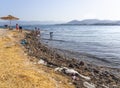 Chalkida, Evia island. July 2019: Panoramic view of the city beach of Liani Ammos with tourists and Gypsies, polluted with garbage