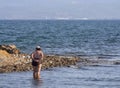 Chalkida, Evia island. July 2019: Panoramic view of the city beach of Liani Ammos with tourists and Gypsies, polluted with garbage