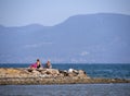 Chalkida, Evia island. July 2019: Panoramic view of the city beach of Liani Ammos with tourists and Gypsies, polluted with garbage