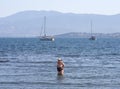 Chalkida, Evia island. July 2019: Panoramic view of the city beach of Liani Ammos with tourists and Gypsies, polluted with garbage