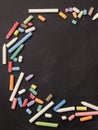 Chalks in a variety of colors arranged on a black background