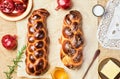 Challah bread, freshly baked sweet braided bread on parchment, sackcloth background. Pomegranates, apples, butter and honey for Royalty Free Stock Photo