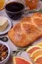 Challah bread, oranges, coffee, granola, butter and apricot jam on the table Royalty Free Stock Photo