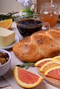 Challah bread, oranges, coffee, granola, butter and apricot jam on the table Royalty Free Stock Photo
