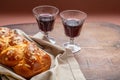 Challah bread with two glasses of red wine on wooden table, copy space Royalty Free Stock Photo