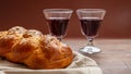 Challah bread with two glasses of red wine on wooden table Royalty Free Stock Photo