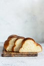 Challah or Hala is a traditional jewish sweet fresh sabbath Braided bread loaf, fresh bun on cutting board.