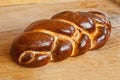 Challah lying on a wooden table