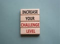 Challenge Level symbol. Concept word Increase your Challenge Level on wooden blocks. Beautiful grey green background. Business and