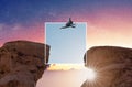 Challenge, risk, freedom and carefree concept. Silhouette a man jumping over precipice crossing cliff with colorful sky