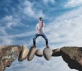 Challenge stones. Businessman in battle position standing on rocks between