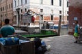 Men loading trash on garbage boat, Venice Royalty Free Stock Photo