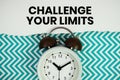 Challenge Your Limits text written on paper with alarm clock on green chevron background Royalty Free Stock Photo