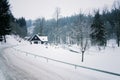 Cottage in snowy mountains country, foggy winter day, Czech republic