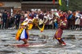 A Cham dancer with deer mask bending his body, a joker behind him and copy his motion, Haa Tshechu, Bhutan Royalty Free Stock Photo