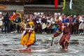 A Cham dancer with deer mask bending his body, a joker behind him and copy his motion, Haa Tshechu, Bhutan Royalty Free Stock Photo