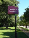 Chamber of Commerce Signpost along Tree-Lined Sidewalk Royalty Free Stock Photo