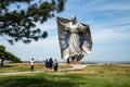 People gather around the Dignity Statue in a Chamberlain rest area, a tribute to the