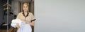 Chambermaid holding stack of fresh towels in hotel room Royalty Free Stock Photo