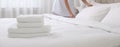 Chambermaid making bed in hotel room, focus on fresh towels. Banner design Royalty Free Stock Photo