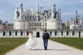 Chambord Castle, France. pair of lovers, couple dancing and hugging on alley