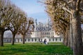 Chambord Castle, France. pair of lovers, couple sitting on bench on alley