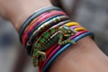 chameleon camouflaged among multicolored bangles on wrist