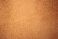Chamois texture, light brown suede. Shabby leather background, natural skin pattern. Rough fabric surface