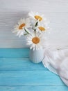 chamomile bouquet shawl of a blossom natural vase retro textile on a wooden arrangement background, fabric
