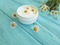 Chamomile flower, cosmetic extract skin cream product on a blue wooden background Royalty Free Stock Photo