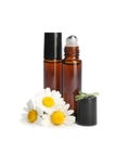 Chamomile flowers and cosmetic bottles of essential oil