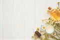 Chamomile flowers and cosmetic bottles of essential oil and extract on white wooden background. Flat lay. Top view. Copy space Royalty Free Stock Photo