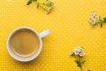 Chamomile Flowers And A Cup Of Coffee On A Yellow Polka Dot Background