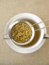 Chamomile flowers tea in tea strainer