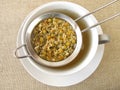Chamomile flowers tea in tea strainer