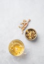 Chamomile herbal tea in a glass cup on a light background with dry flowers. The concept of a healthy detox drink for health and Royalty Free Stock Photo